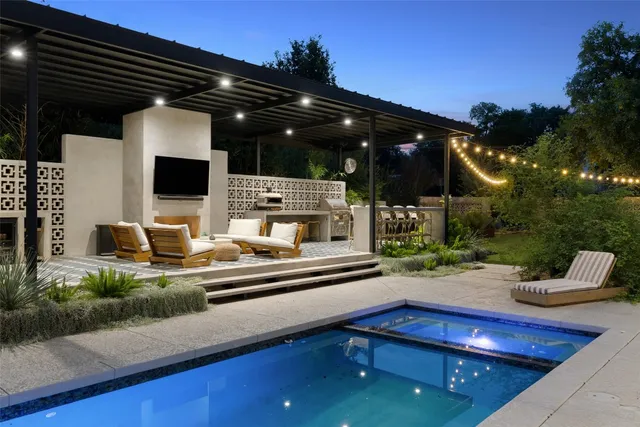 a view of swimming pool with outdoor seating