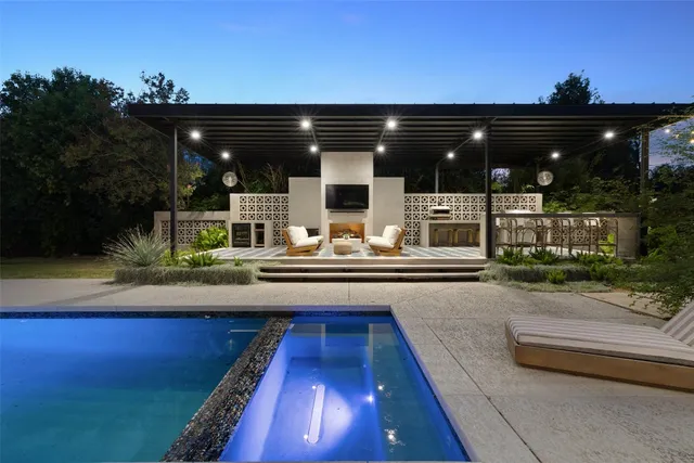 a view of a patio with swimming pool table and chairs