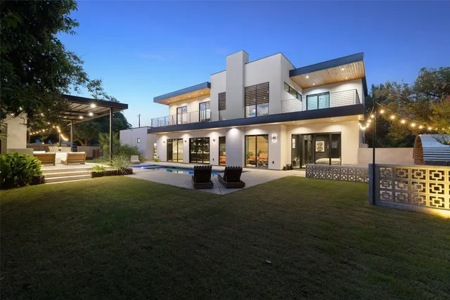 a front view of house and yard with swimming pool and outdoor seating