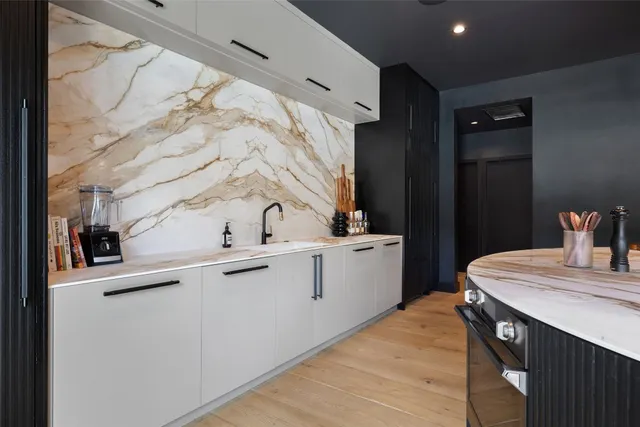 a living room with furniture and large windows