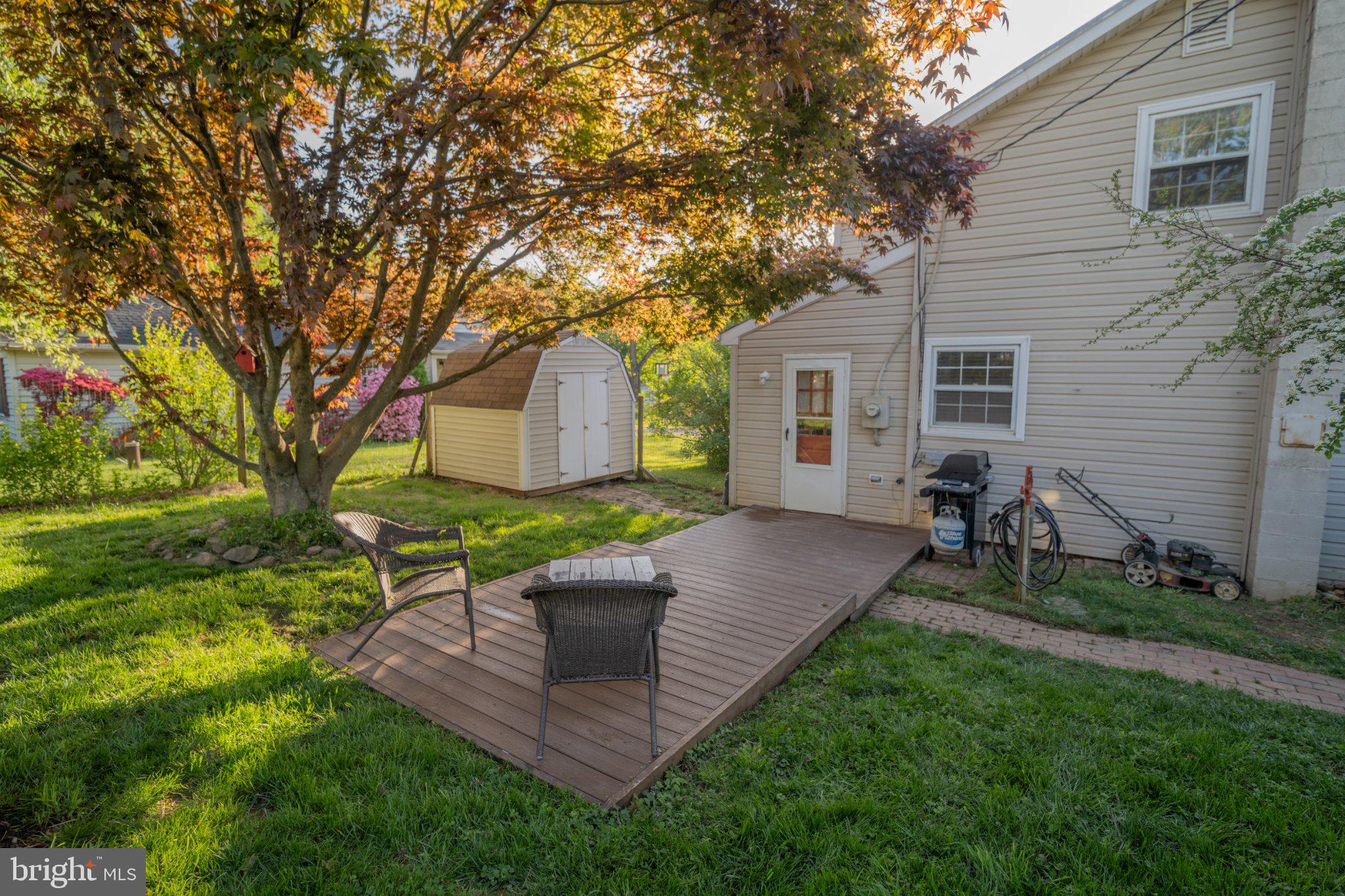 430 Pine Grove Road Bluemont, VA 20135 - Photo 11 of 58 a view of a backyard with table and chairs potted plants and large tree