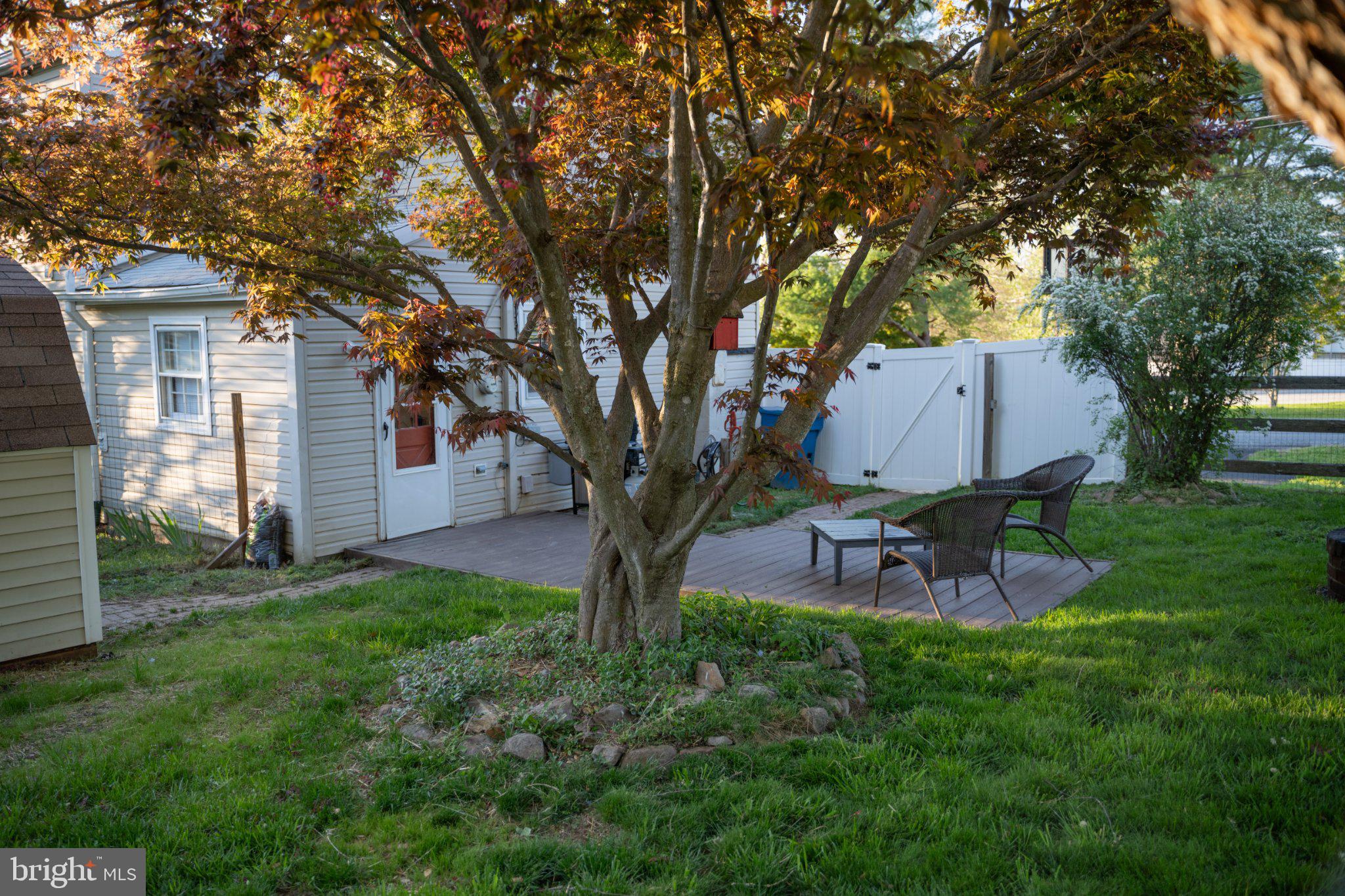 430 Pine Grove Road Bluemont, VA 20135 - Photo 15 of 58 a backyard of a house with table and chairs