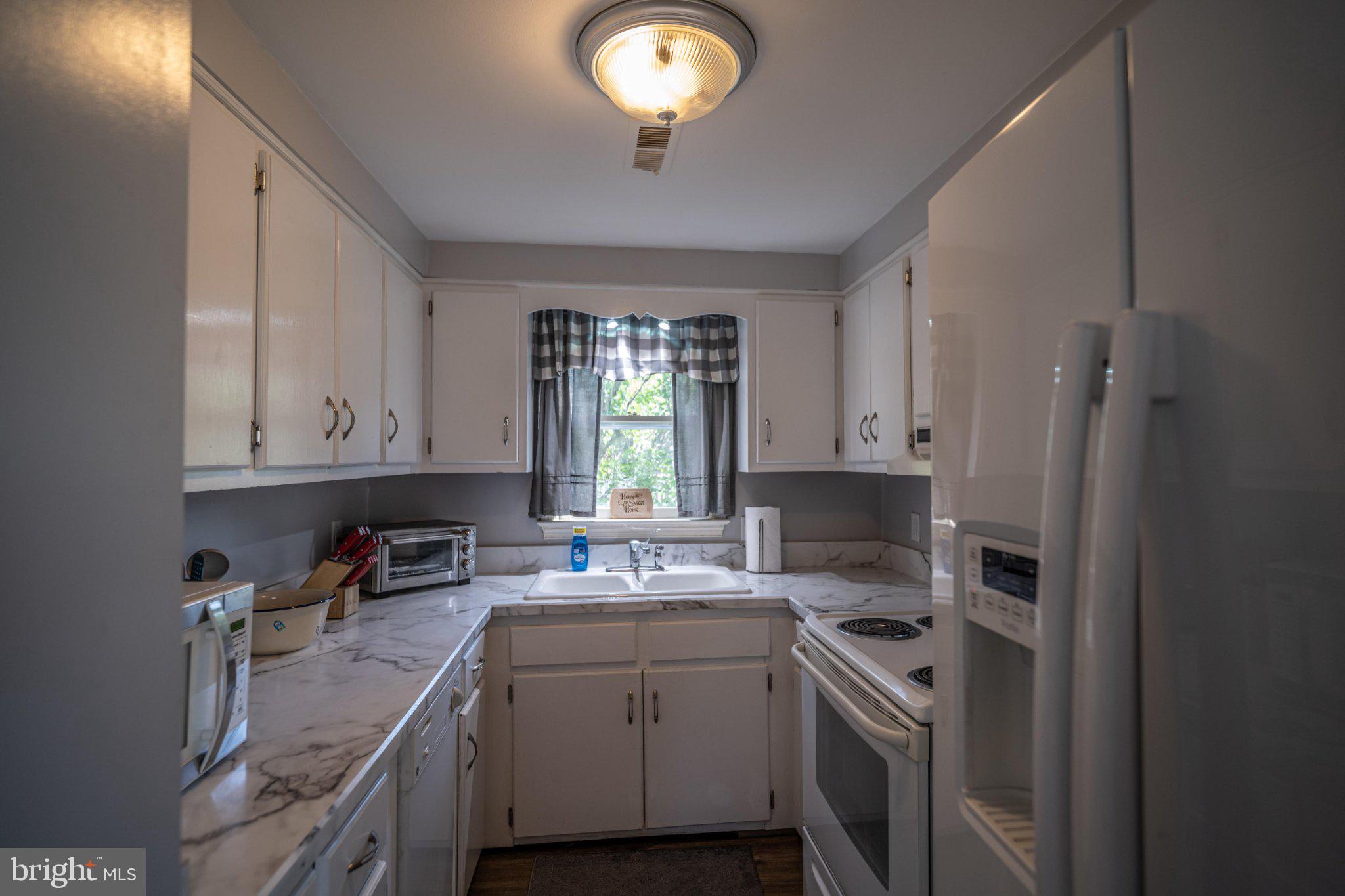 430 Pine Grove Road Bluemont, VA 20135 - Photo 37 of 58 a kitchen with a stove sink and cabinets