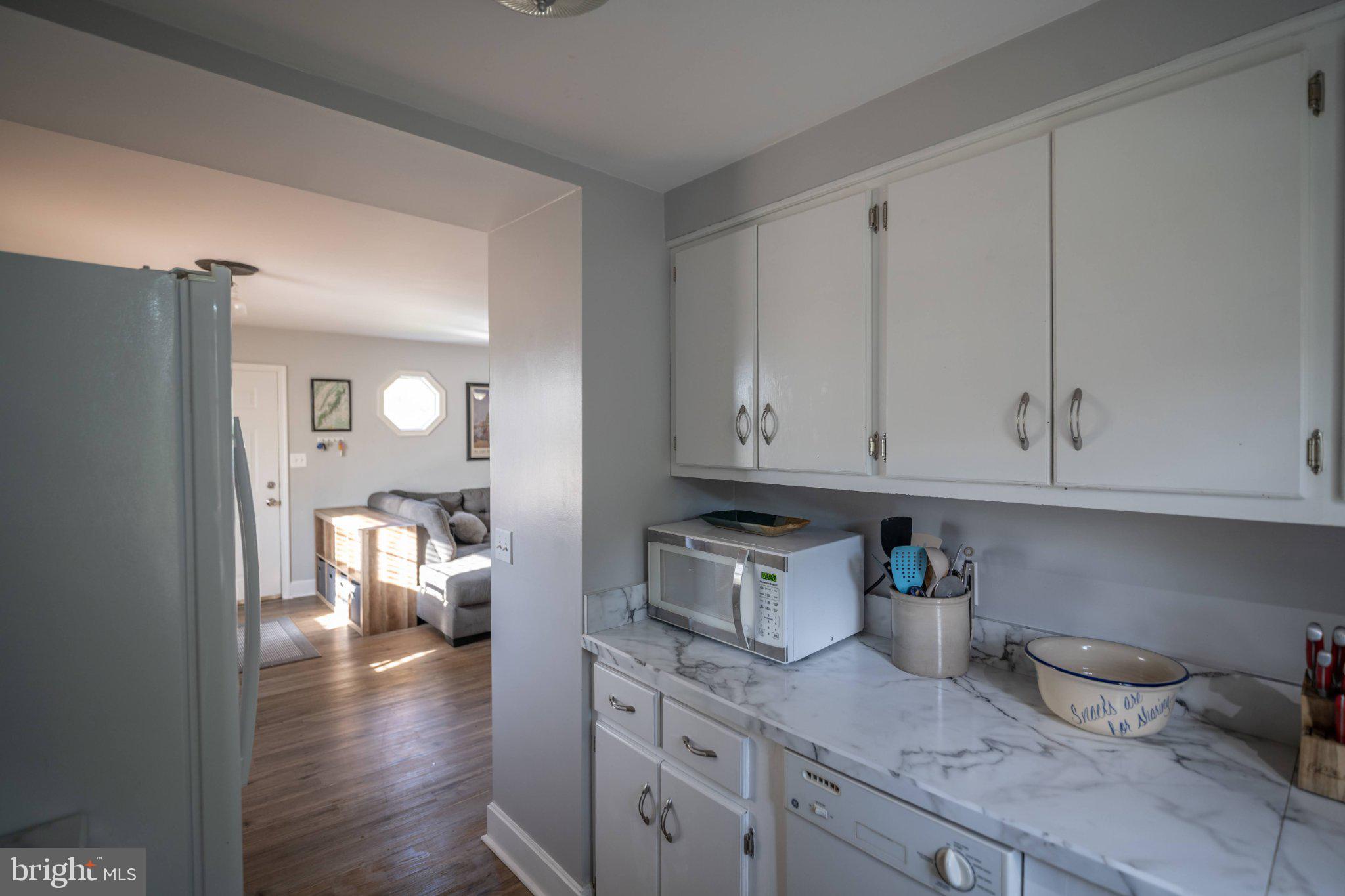 430 Pine Grove Road Bluemont, VA 20135 - Photo 38 of 58 a kitchen with granite countertop a sink dishwasher stove and cabinets