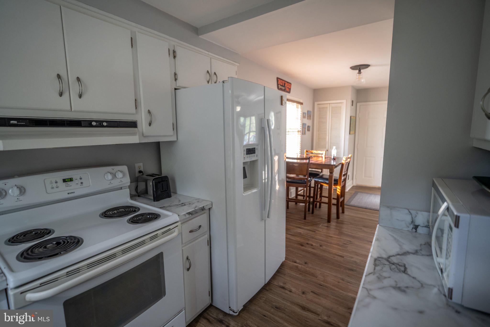 430 Pine Grove Road Bluemont, VA 20135 - Photo 40 of 58 a kitchen with a stove a refrigerator and a dining table