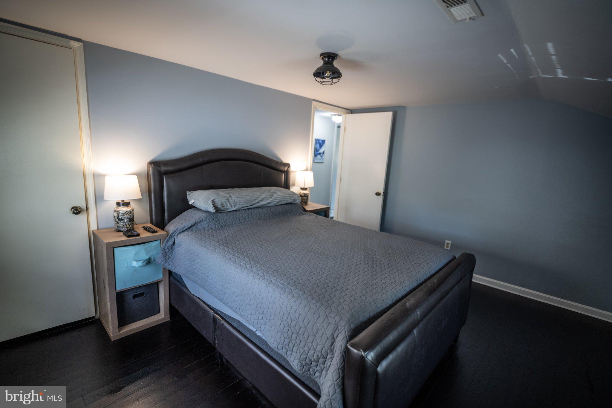 430 Pine Grove Road Bluemont, VA 20135 - Photo 45 of 58 a bedroom with a bed and a lamp on table