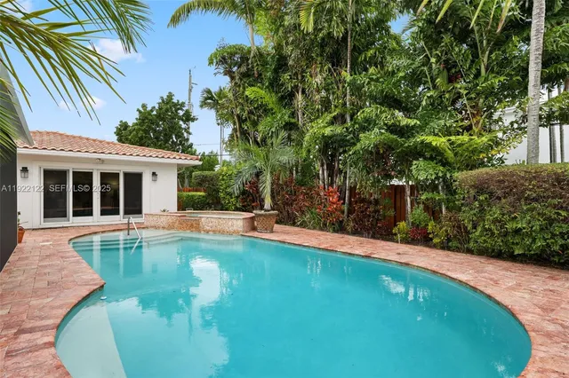 a view of a house with swimming pool and a porch