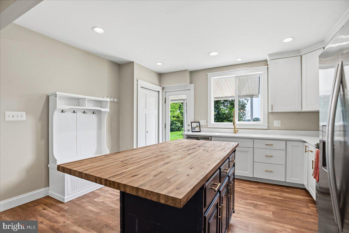 16146 Thomas Road Piney Point, MD 20674 - Photo 19 of 70 a kitchen with a stove a sink a refrigerator and a dining table