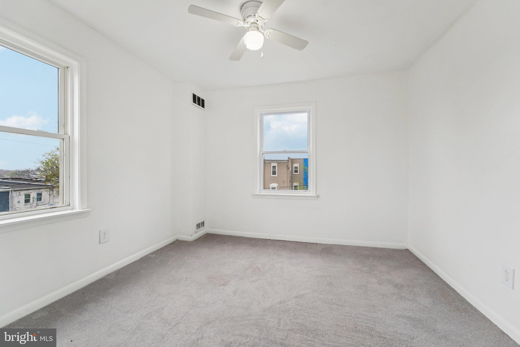 800 Stoll Street Baltimore, MD 21225 - Photo 20 of 24 an empty room with a window and a fan