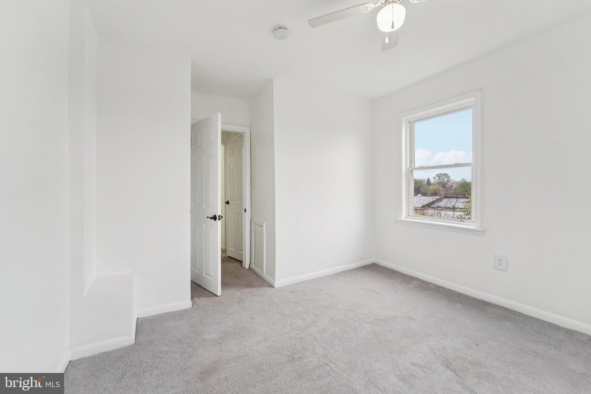 800 Stoll Street Baltimore, MD 21225 - Photo 21 of 24 an empty room with windows and closet
