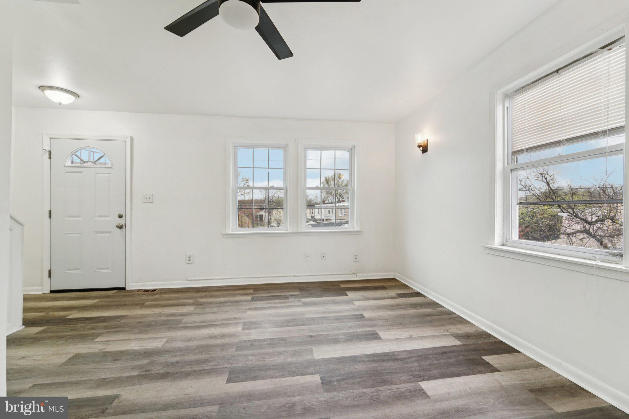 800 Stoll Street Baltimore, MD 21225 - Photo 5 of 24 a view of an empty room with window and a ceiling fan