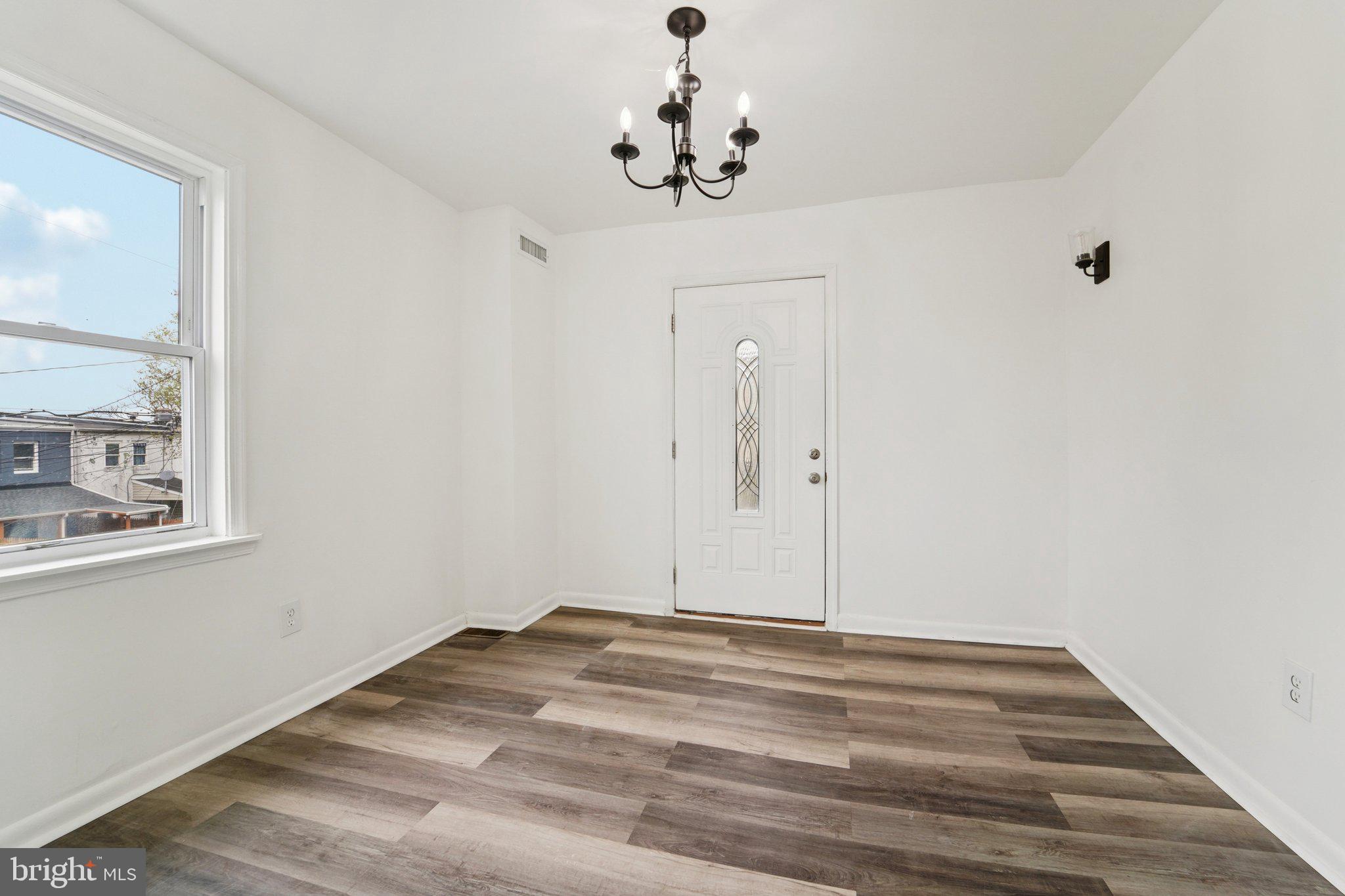 800 Stoll Street Baltimore, MD 21225 - Photo 6 of 24 a view of a chandelier fan and wooden floor