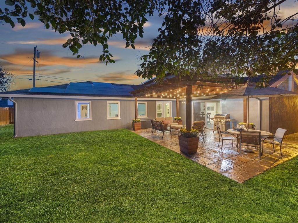 203 Doris Drive Pleasant Hill, CA 94523 - Photo 20 of 22 a view of a backyard with table and chairs potted plants and large tree