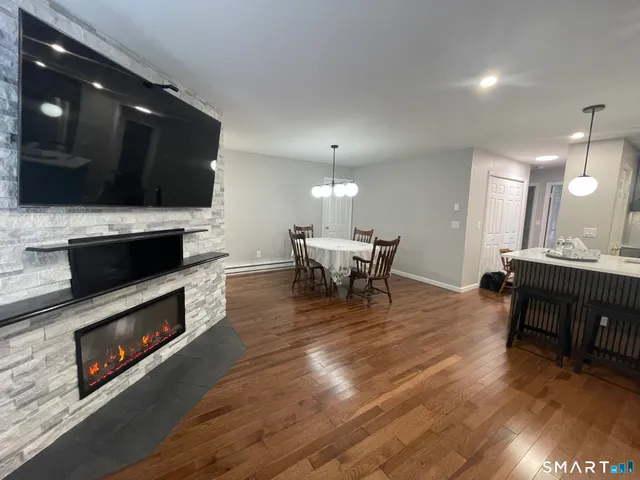 a living room with furniture fireplace and flat screen tv