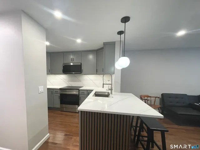 a kitchen with a sink cabinets and appliances