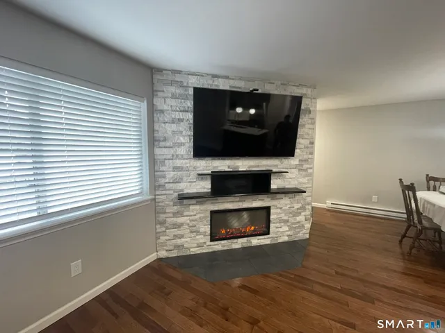 a living room with a fireplace and a flat screen tv