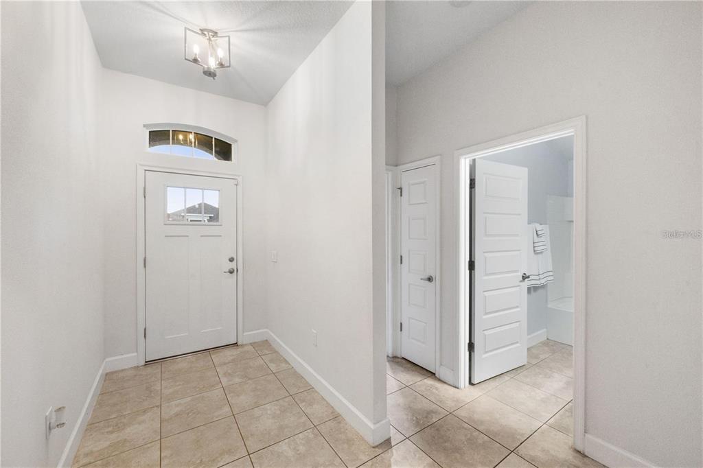 14429 Potterton Circle Hudson, FL 34667 - Photo 14 of 36 a view of a hallway with windows and chandelier
