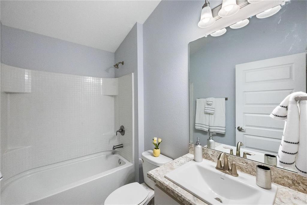 14429 Potterton Circle Hudson, FL 34667 - Photo 16 of 36 a bathroom with a sink a toilet and shower