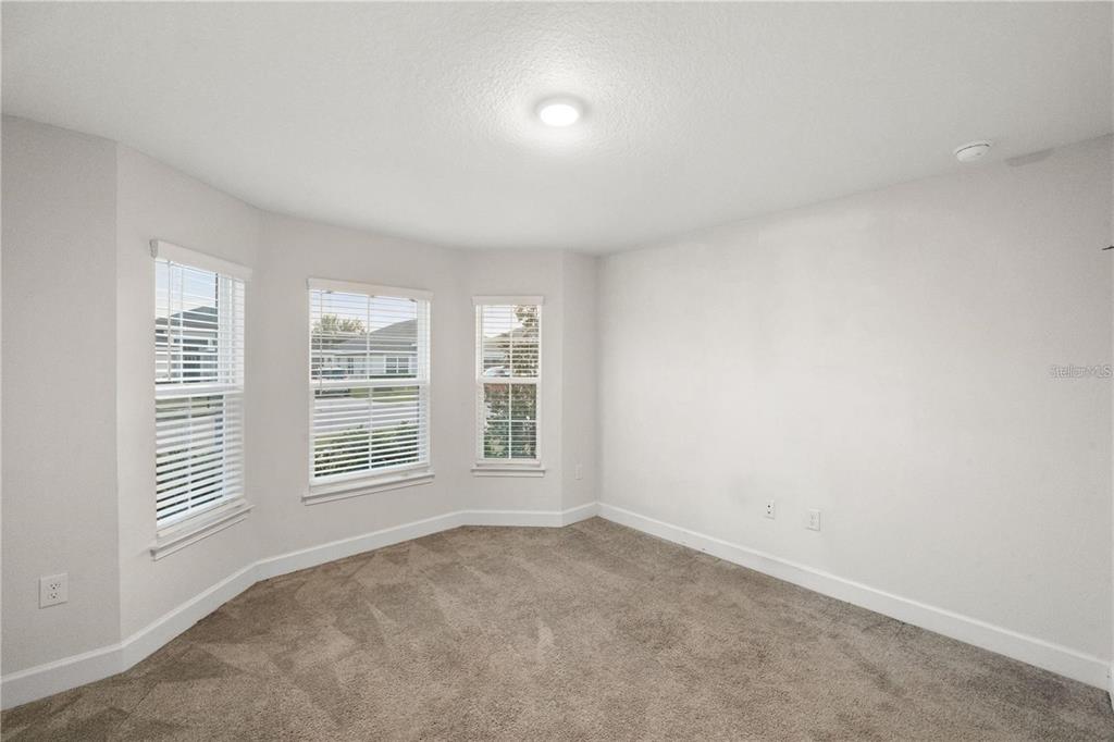 14429 Potterton Circle Hudson, FL 34667 - Photo 17 of 36 an empty room with windows