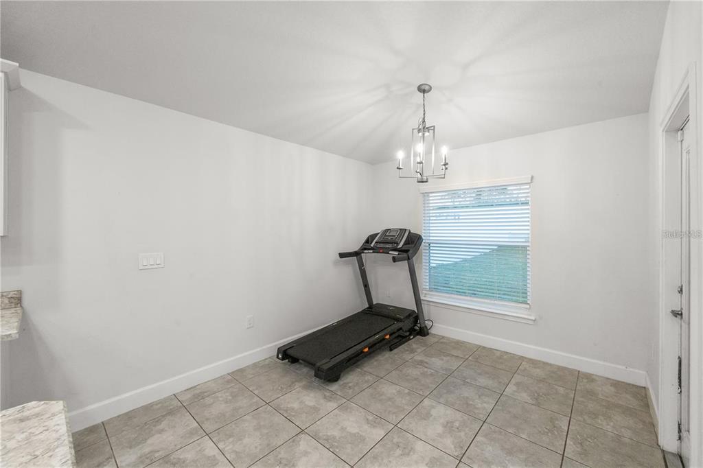 14429 Potterton Circle Hudson, FL 34667 - Photo 26 of 36 a room with gym equipment and view of living room