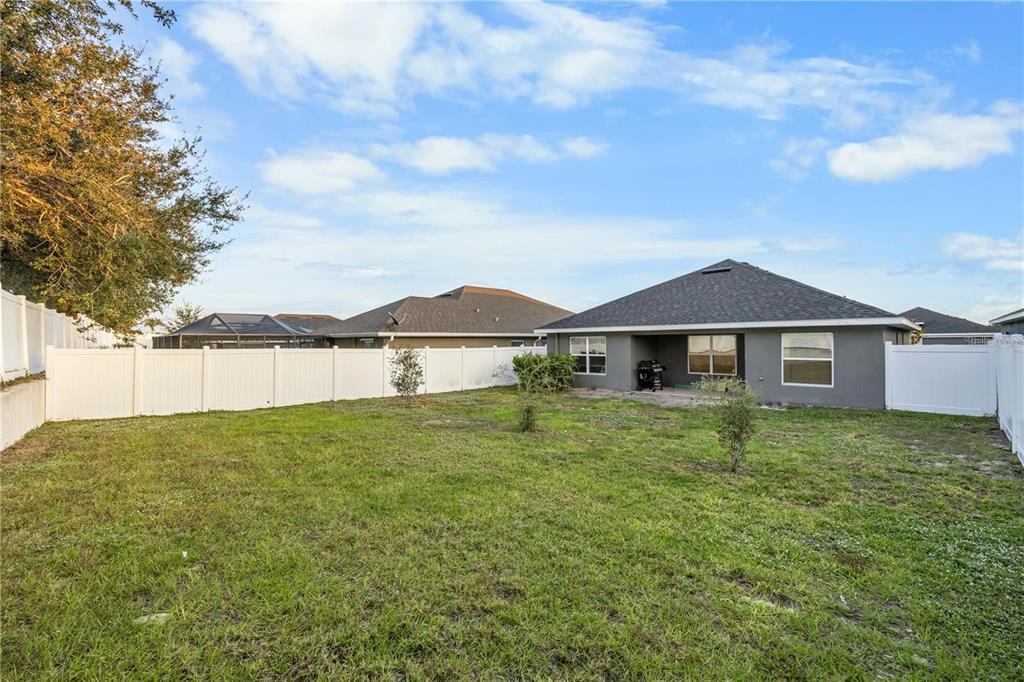 14429 Potterton Circle Hudson, FL 34667 - Photo 30 of 36 a front view of a house with garden
