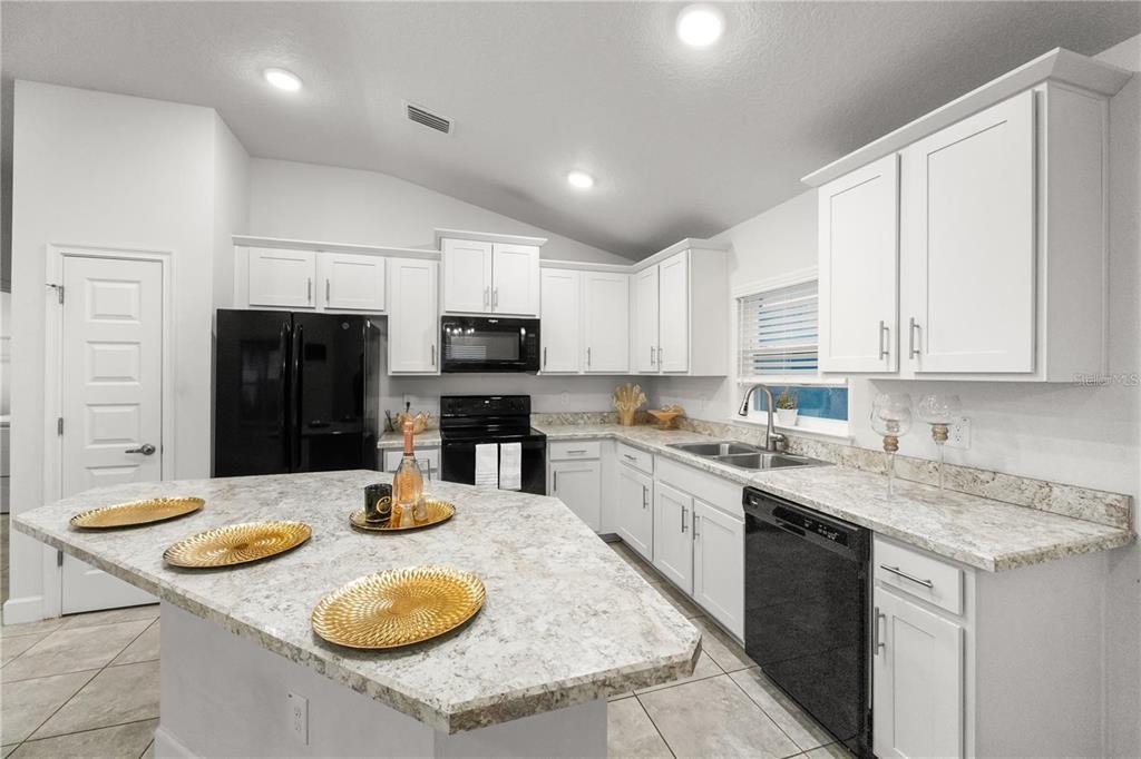 14429 Potterton Circle Hudson, FL 34667 - Photo 4 of 36 a kitchen with sink and refrigerator