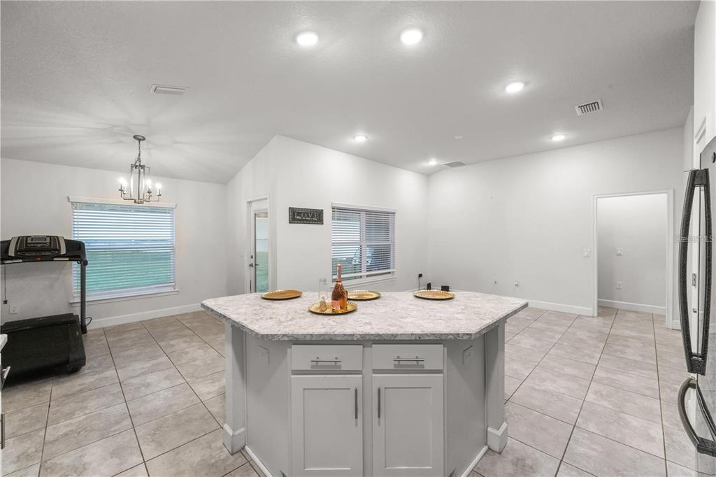 14429 Potterton Circle Hudson, FL 34667 - Photo 6 of 36 a kitchen with stainless steel appliances granite countertop a sink and a refrigerator