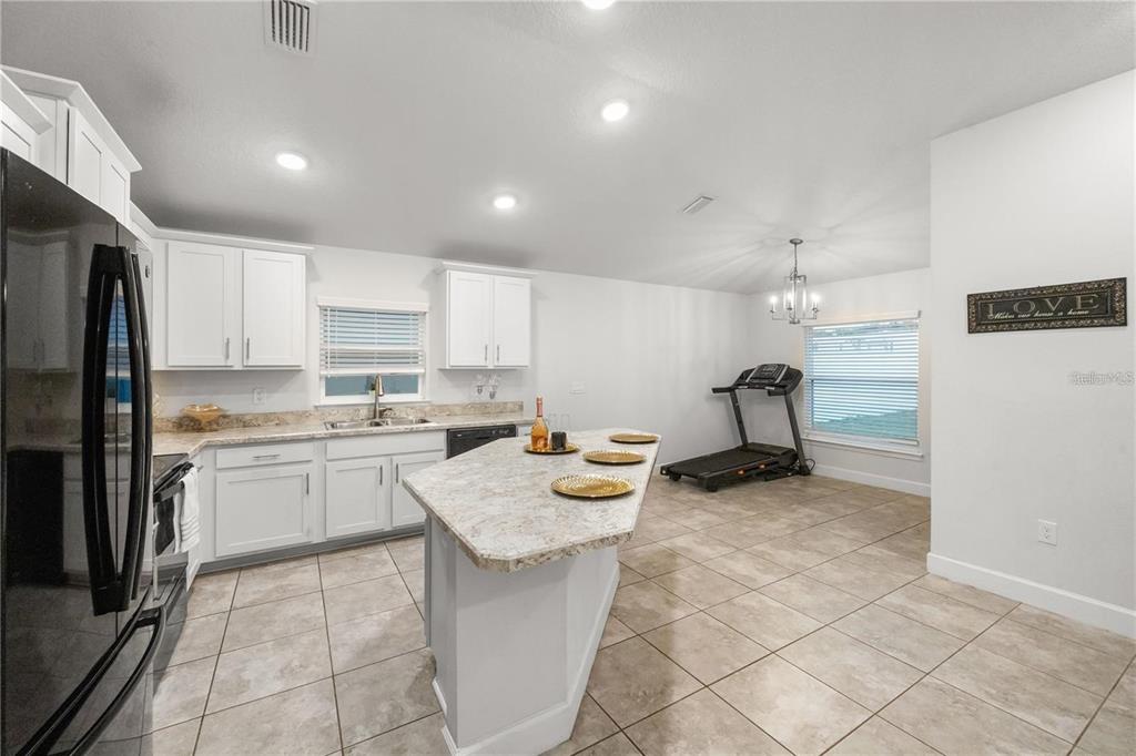 14429 Potterton Circle Hudson, FL 34667 - Photo 9 of 36 a kitchen that has a lot of cabinets in it and appliances