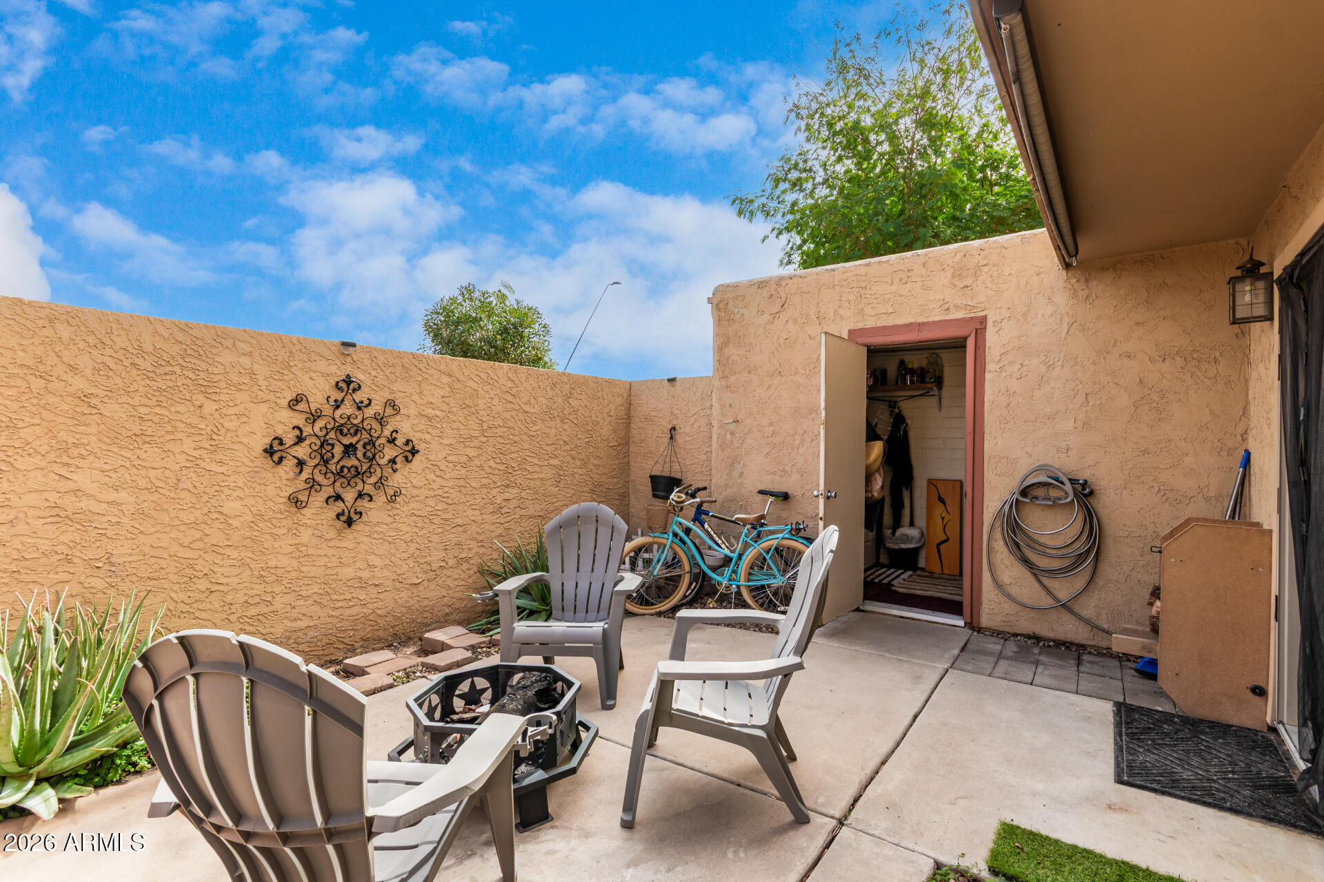a view of a patio with iron fence