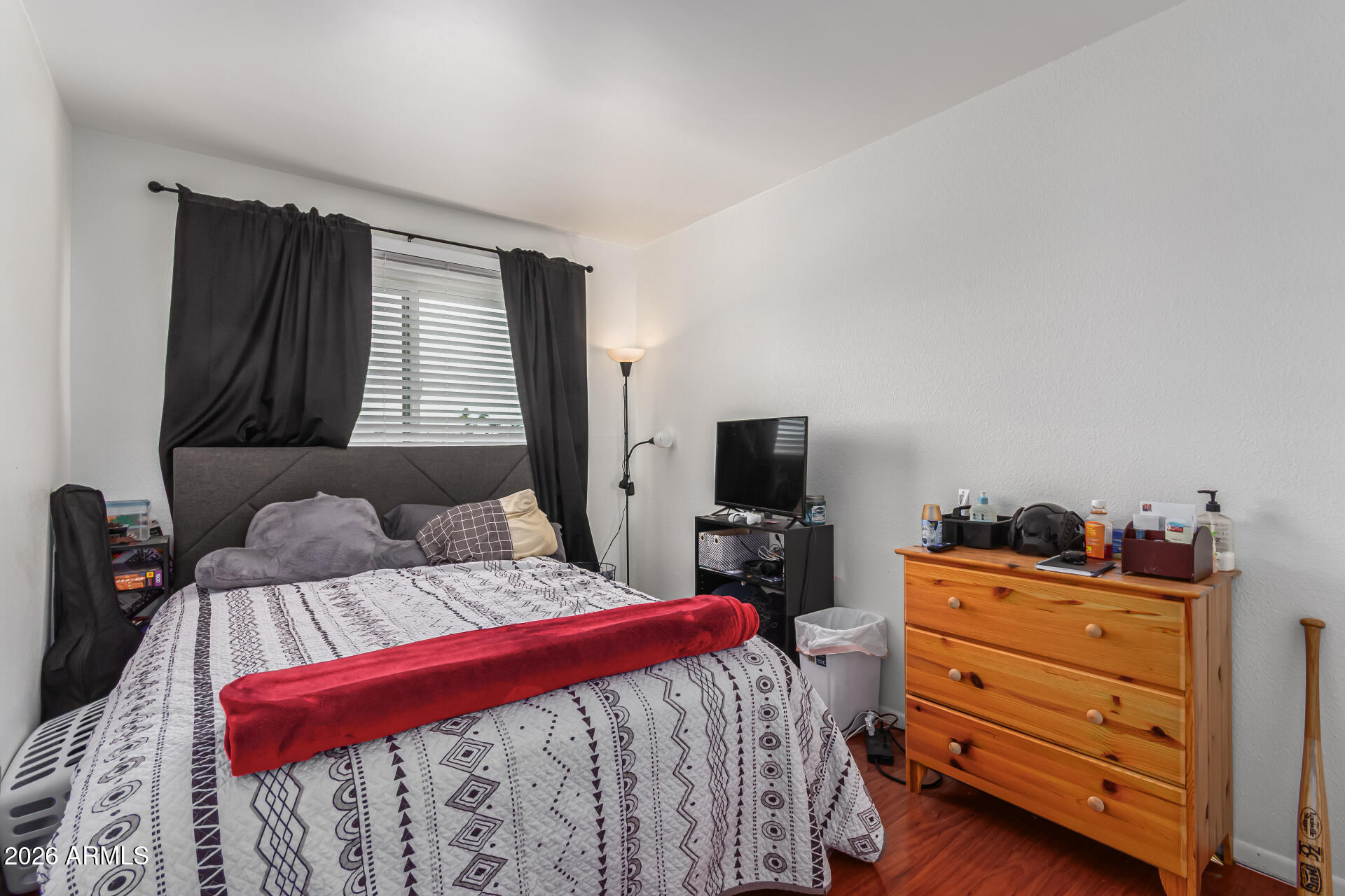 948 South Alma School Road, Unit 128 Mesa, AZ 85210 - Photo 12 of 18 a bedroom with a bed and flat screen tv