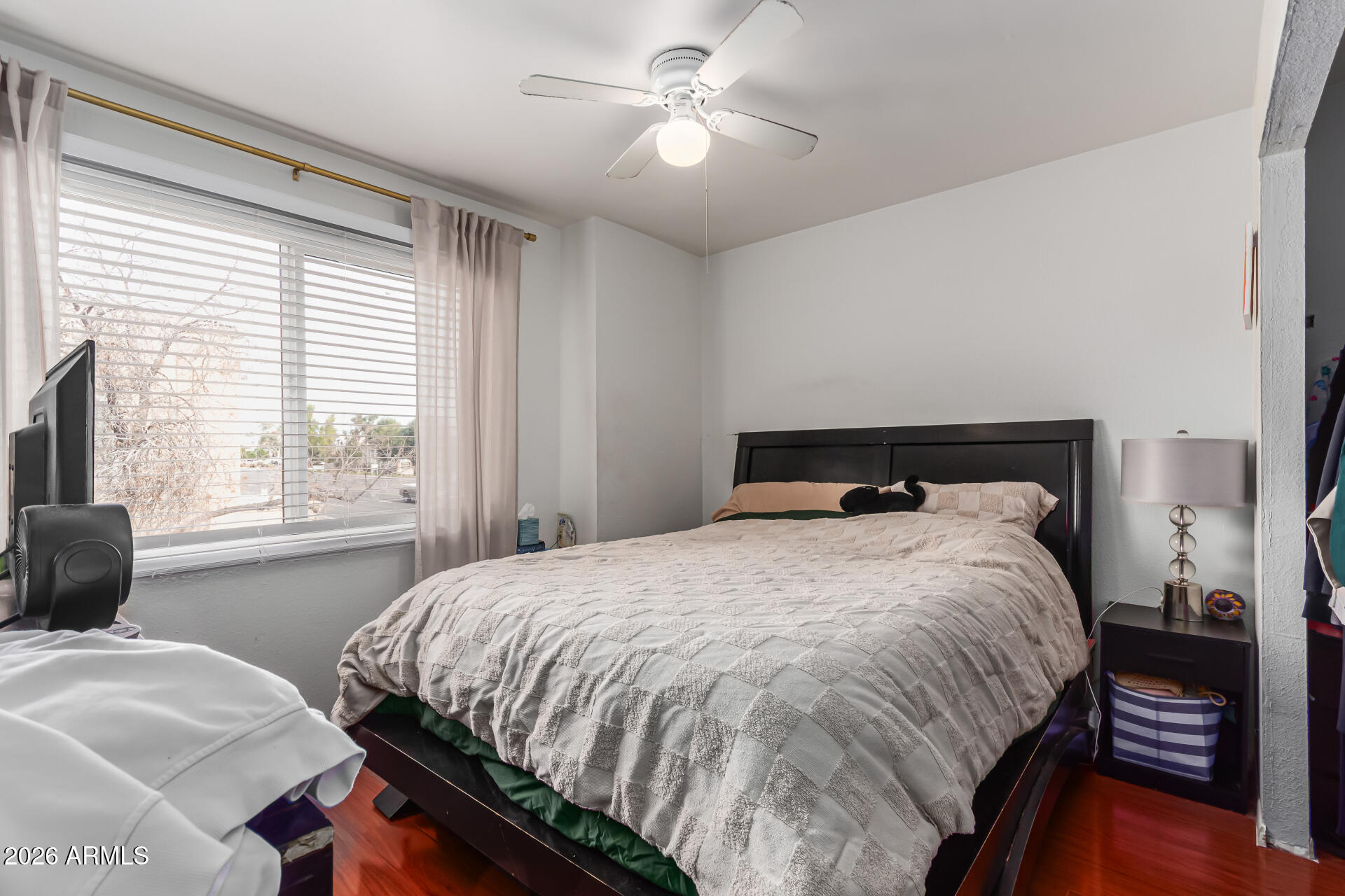 948 South Alma School Road, Unit 128 Mesa, AZ 85210 - Photo 13 of 18 a bedroom with a bed and a window with chair