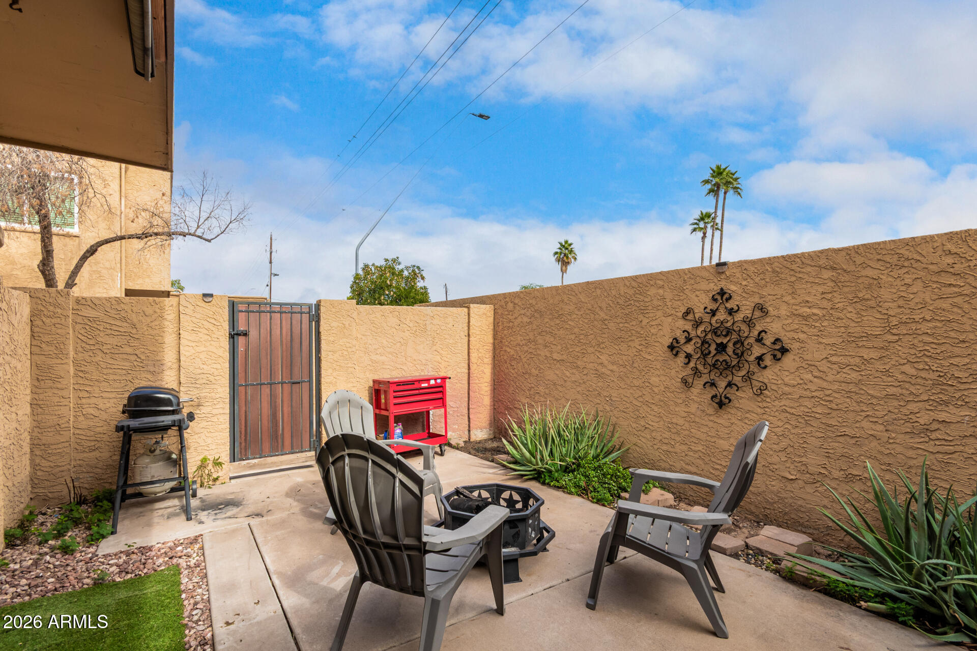 948 South Alma School Road, Unit 128 Mesa, AZ 85210 - Photo 3 of 18 a balcony with table and chairs