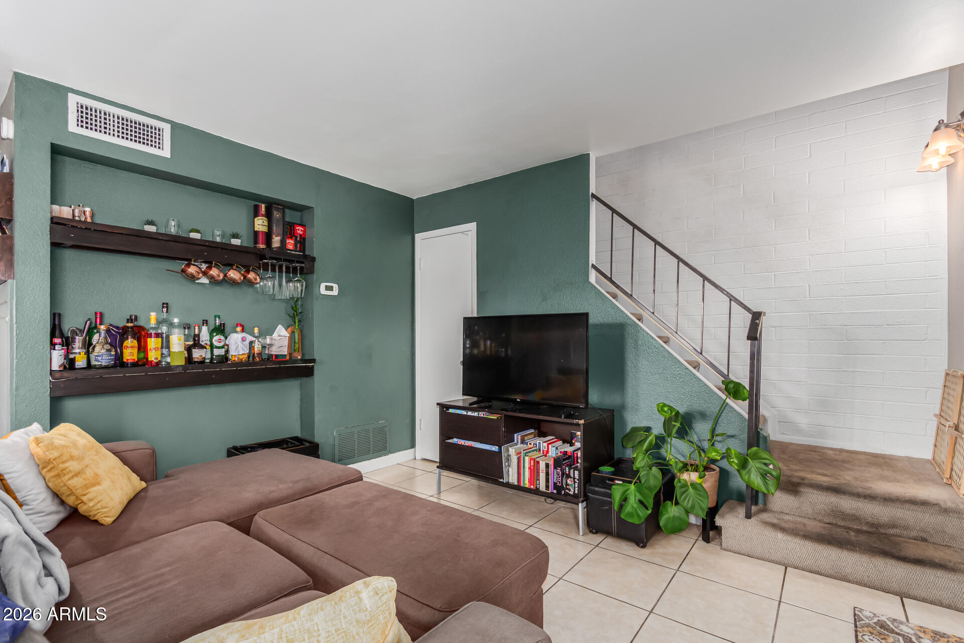 948 South Alma School Road, Unit 128 Mesa, AZ 85210 - Photo 10 of 18 a living room with furniture and a flat screen tv