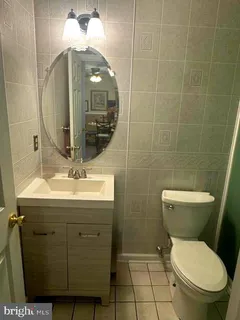 a bathroom with a toilet sink and mirror