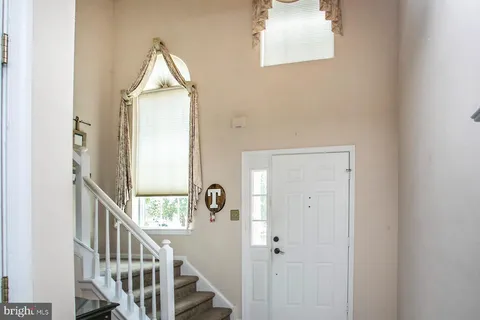 a view of a hallway with wooden floor and entryway
