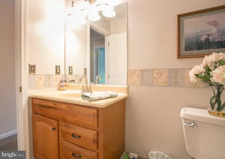 a bathroom with a sink a toilet and a mirror