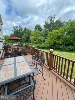 a view of balcony with wooden floor and outdoor seating