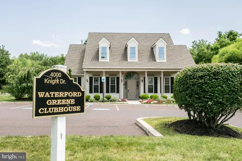 a front view of a house with a yard and potted plants