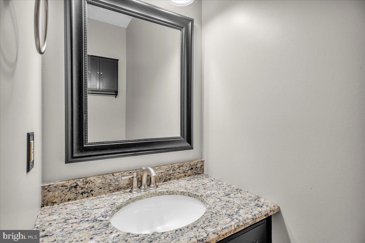28 Winfield Drive Berlin, NJ 08009 - Photo 10 of 34 a bathroom with a granite countertop sink and a mirror