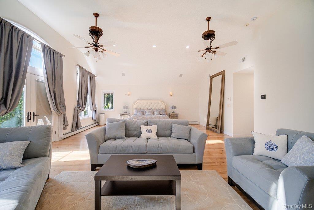 237 Mineral Springs Road Highland Mills, NY 10930 - Photo 21 of 32 Living room featuring wood finished floors, healthy amount of natural light, recessed lighting, baseboard heating, and vaulted ceiling