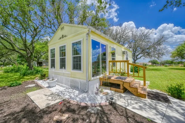 a view of a house with backyard porch and sitting area