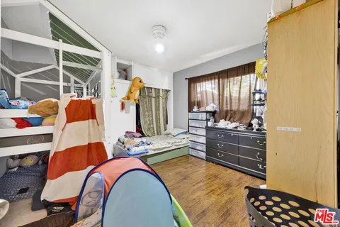 a bedroom with furniture and a window