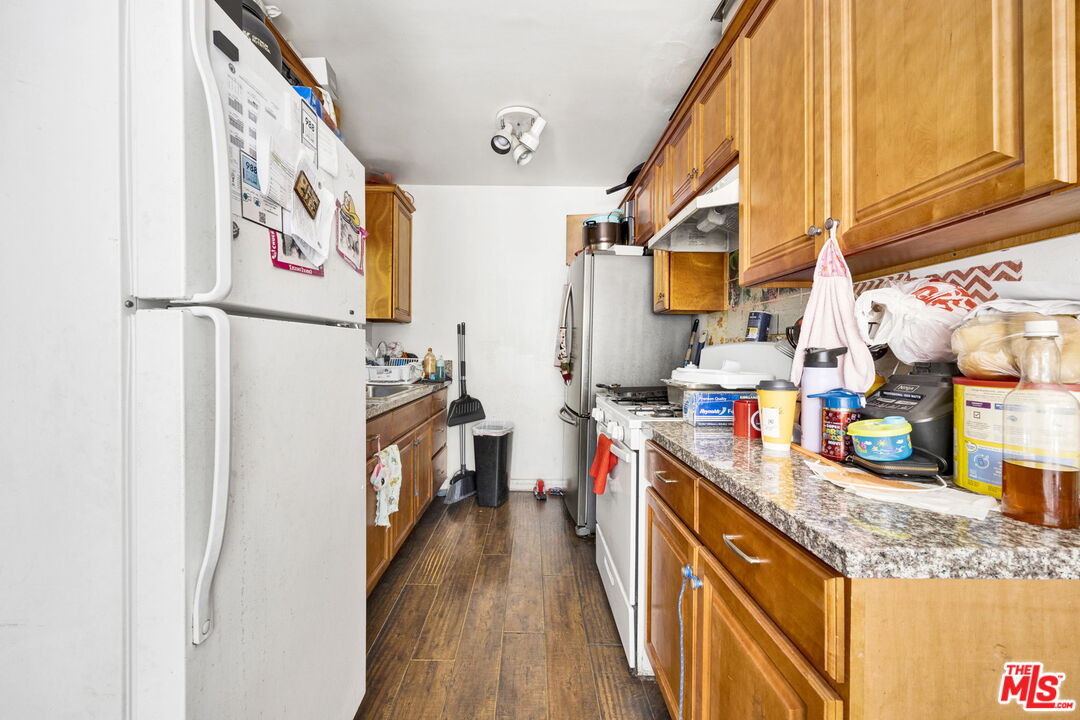 14541 Hart Street Van Nuys, CA 91405 - Photo 20 of 39 a kitchen with stainless steel appliances granite countertop a refrigerator and a stove