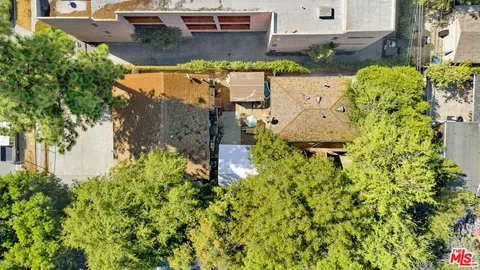 an aerial view of a house with a yard swimming pool