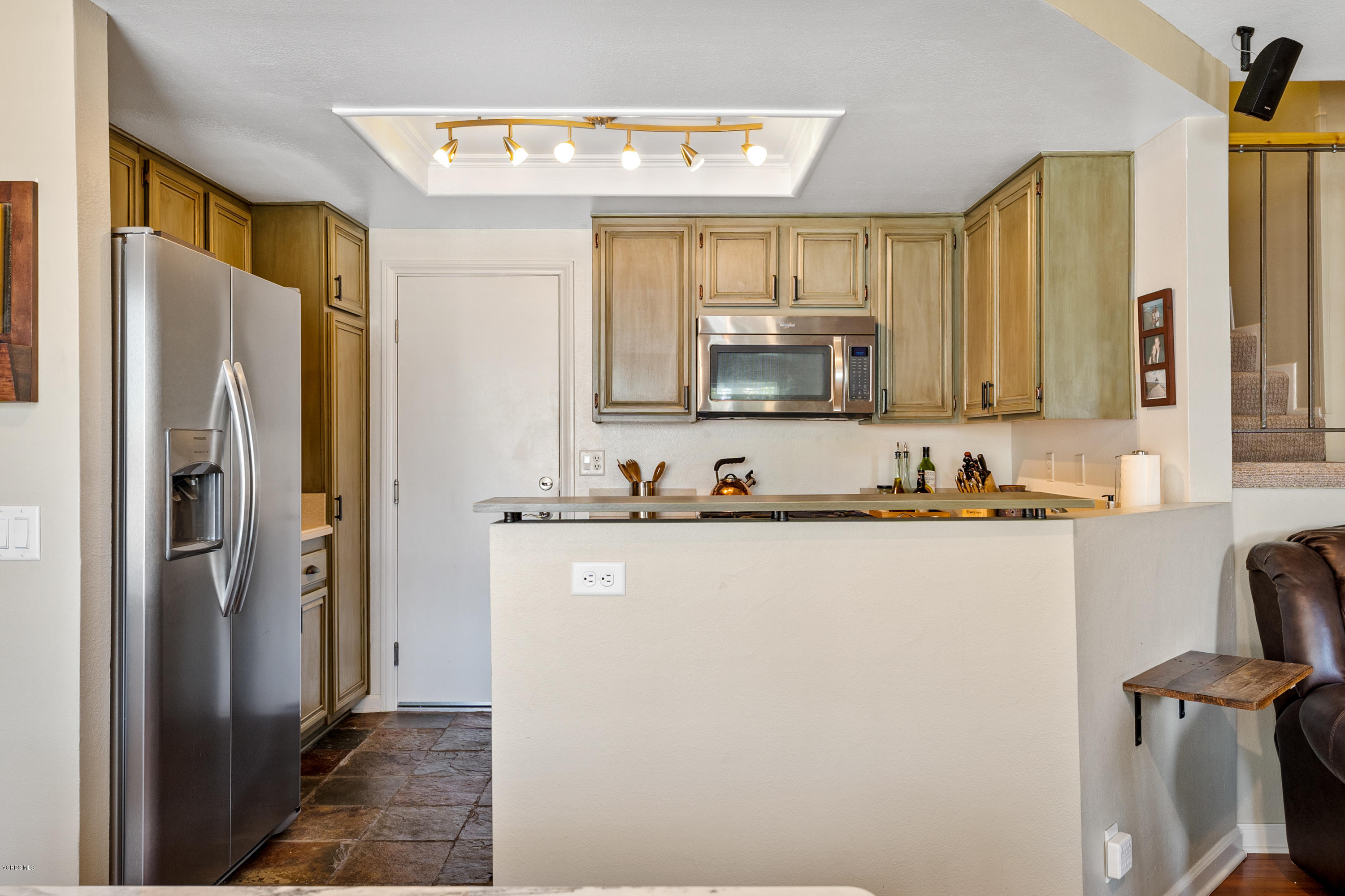 3966 Cochran Street, Unit 72 Simi Valley, CA 93063 - Photo 11 of 26 a kitchen with stainless steel appliances a refrigerator sink and cabinets