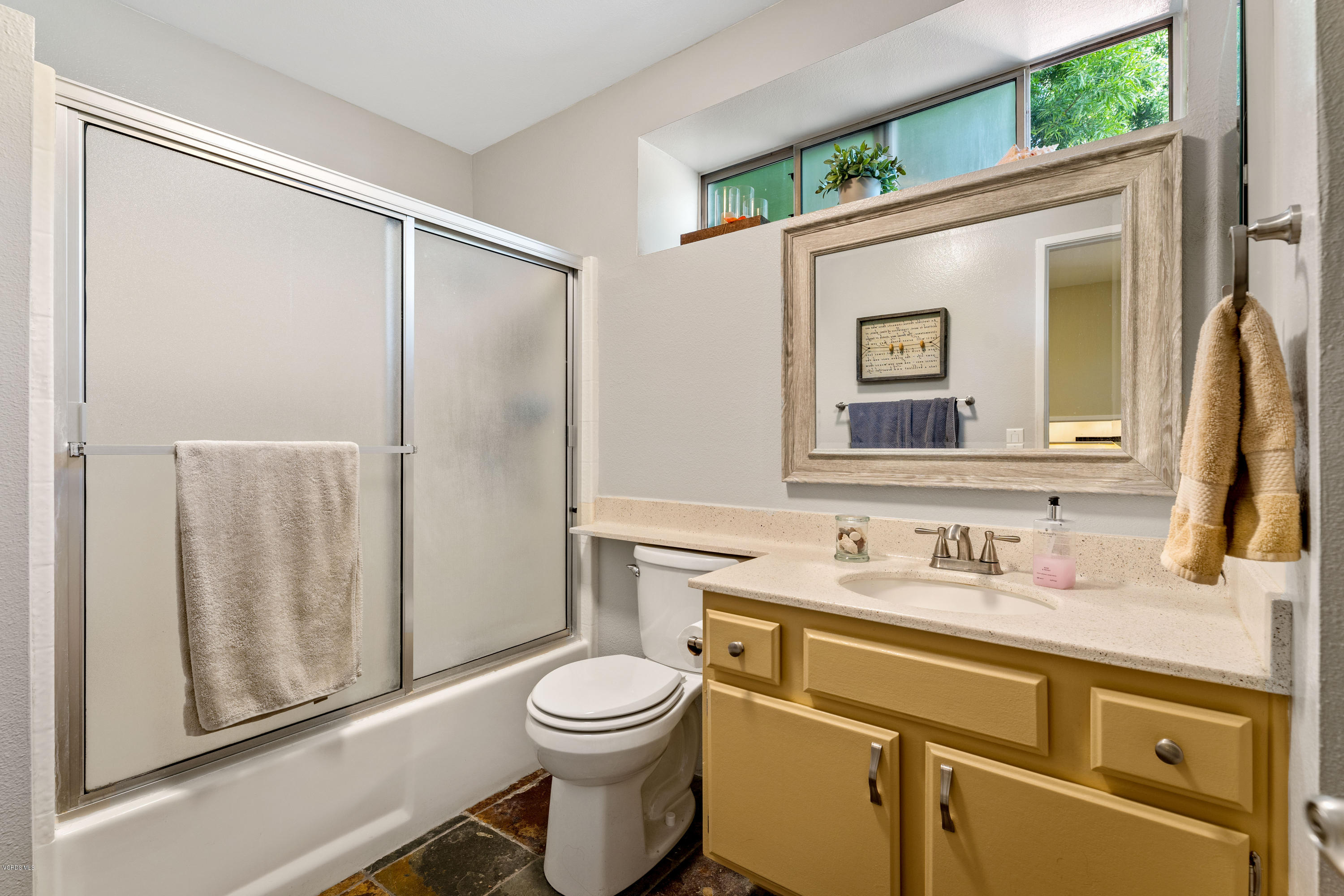 3966 Cochran Street, Unit 72 Simi Valley, CA 93063 - Photo 18 of 26 a bathroom with a toilet sink vanity and mirror