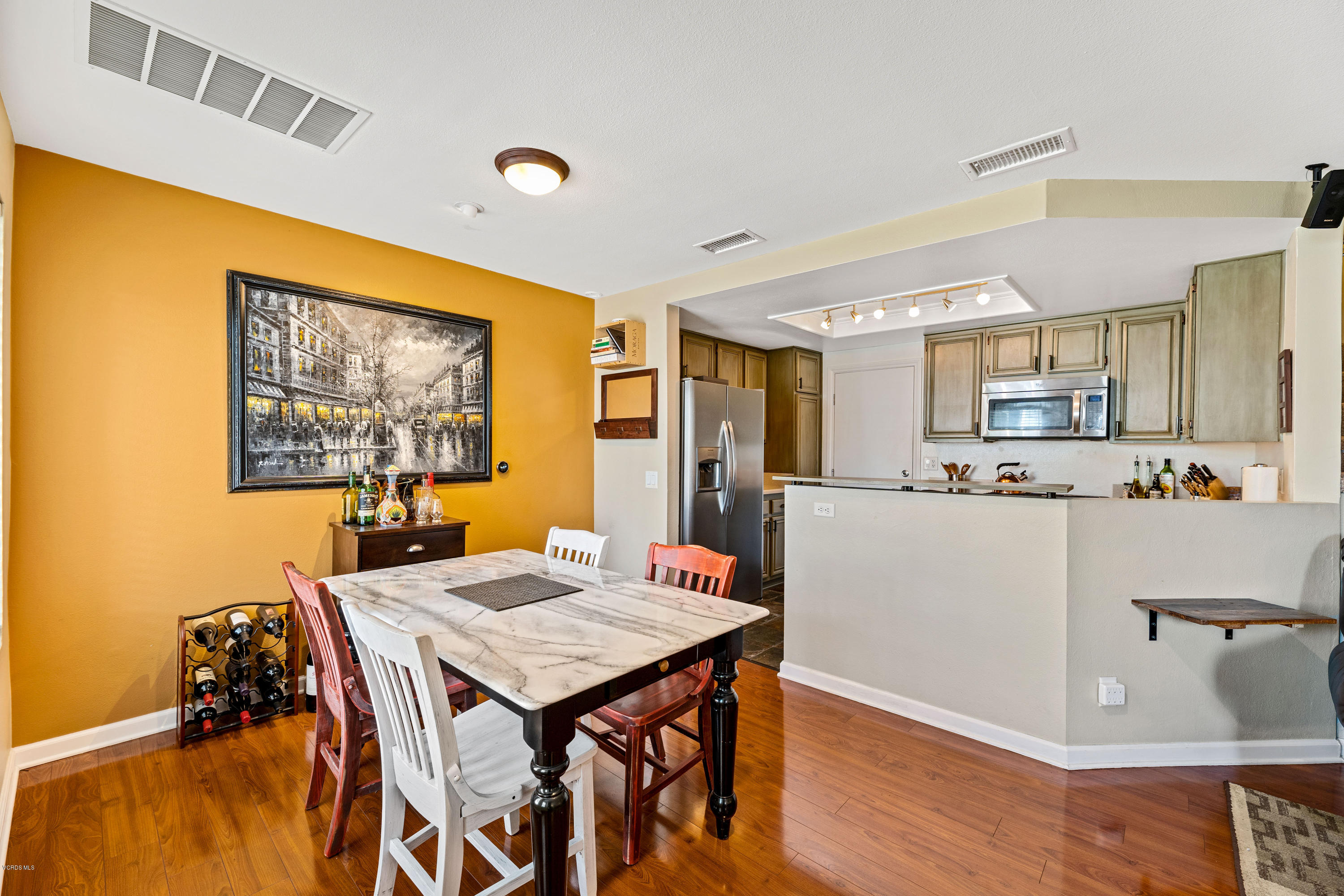 3966 Cochran Street, Unit 72 Simi Valley, CA 93063 - Photo 6 of 26 a living room with stainless steel appliances kitchen island granite countertop furniture and a kitchen view