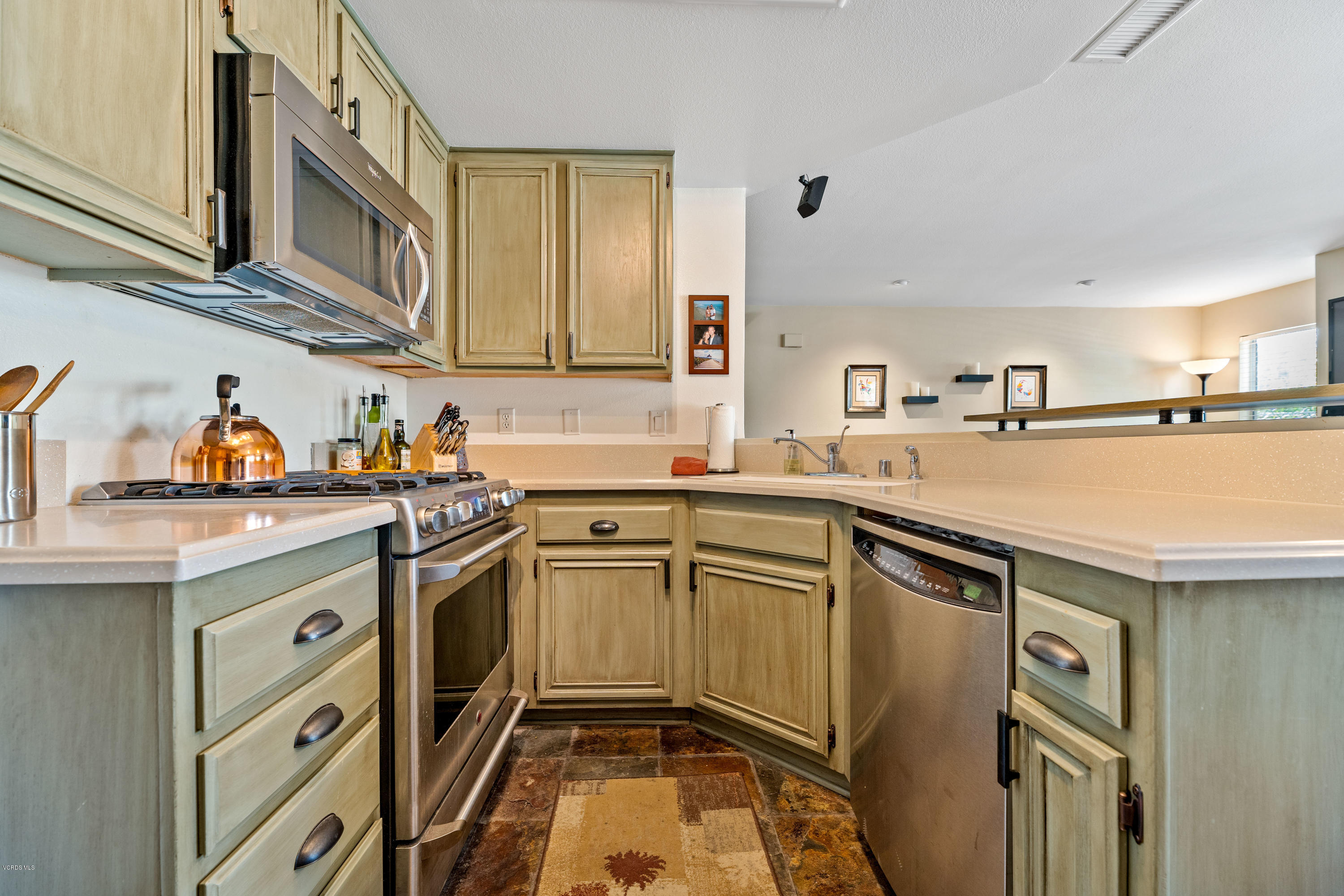3966 Cochran Street, Unit 72 Simi Valley, CA 93063 - Photo 8 of 26 a kitchen with stainless steel appliances granite countertop a sink stove and cabinets