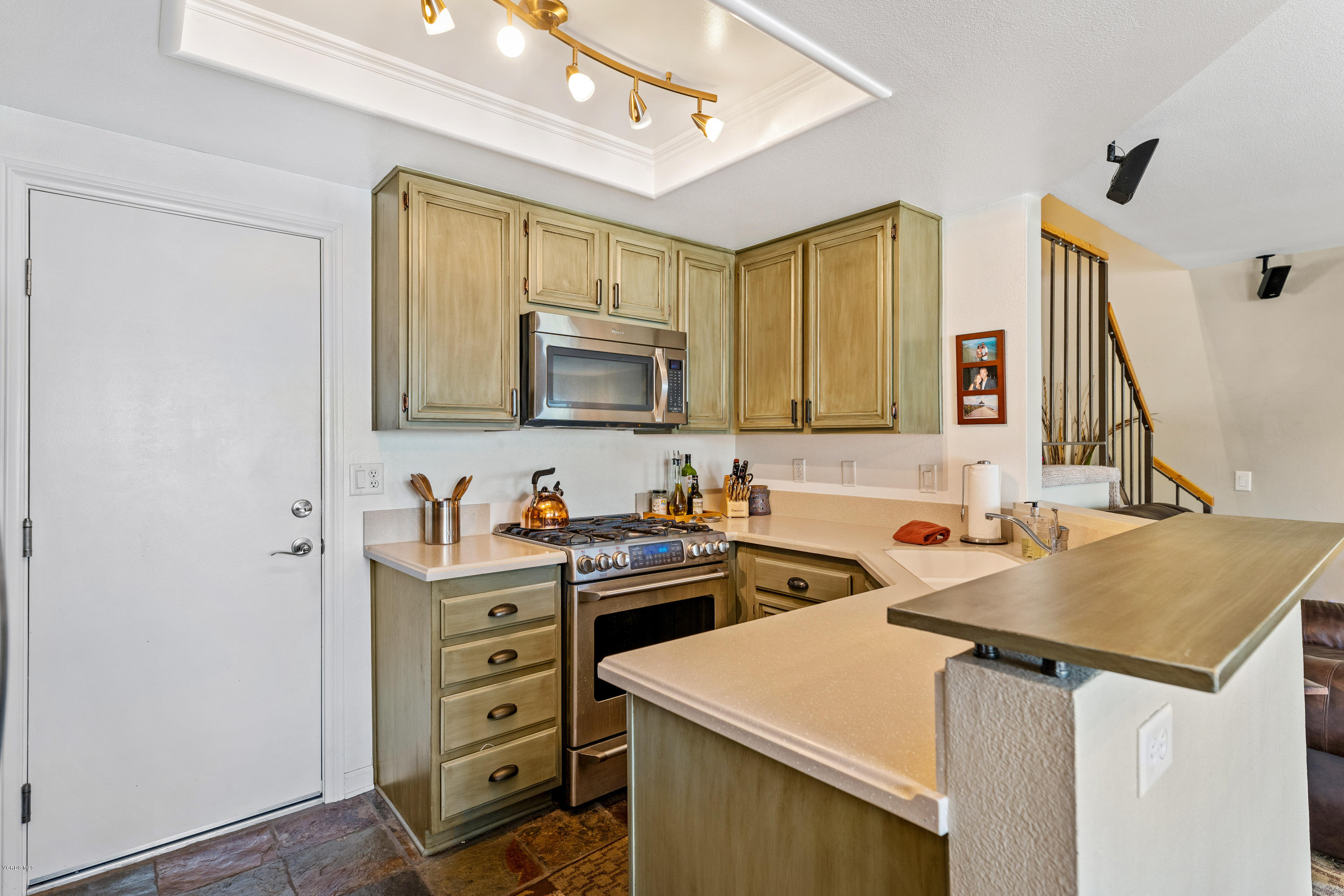 3966 Cochran Street, Unit 72 Simi Valley, CA 93063 - Photo 9 of 26 a kitchen that has a sink and a stove in it