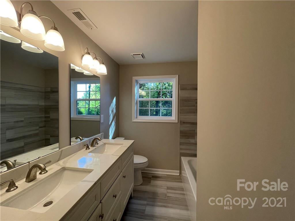 1601 Rushing Street Monroe, NC 28112 - Photo 13 of 21 a bathroom with a double vanity sink and a mirror